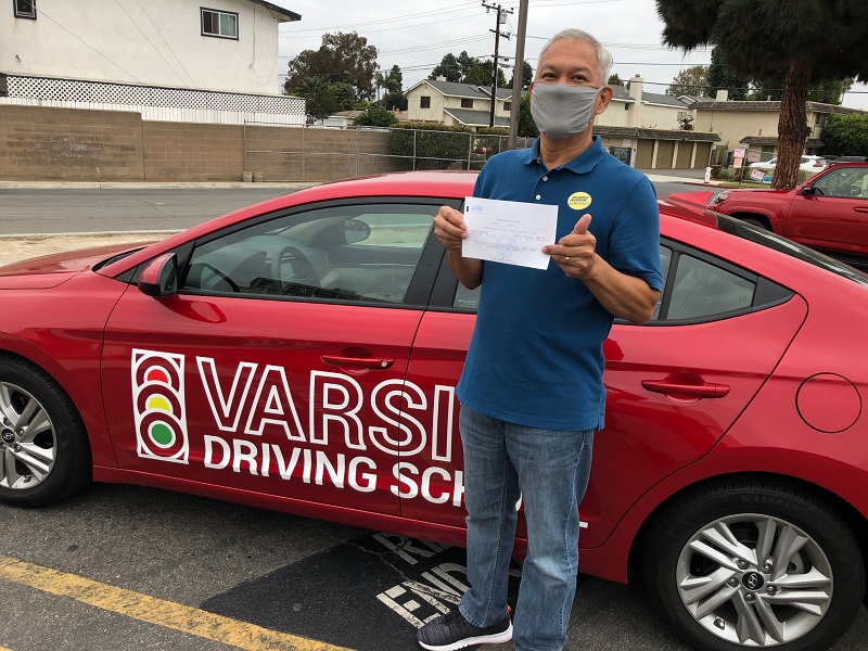 Laguna Niguel Driving School Man Standing Next to a Training Vehicle