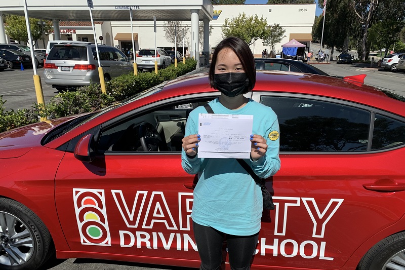Segerstrom Fundamental High School Driving School Student Standing Next to a Training Vehicle