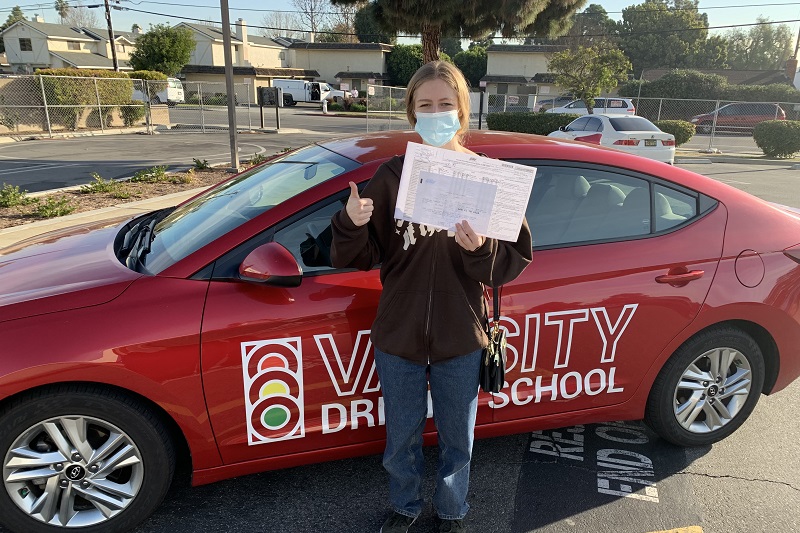 Huntington Beach Driving Lessons Female Student Standing Next to a Training Vehicle