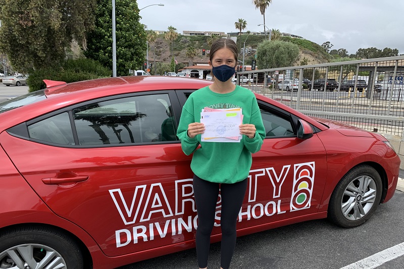 Ocean View High School Driving School Female Student Standing Next to a Training Vehicle