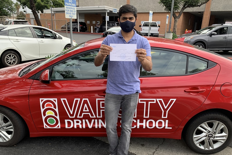 Marina High School Drivers Ed and Driving School Male Student Standing Next to a Training Vehicle