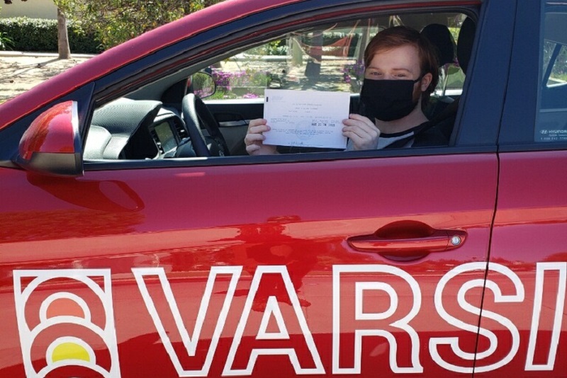 How Much do Driving Lessons Cost in Tustin California Student Inside a Training Vehicle After Taking the Driving Test and Passing