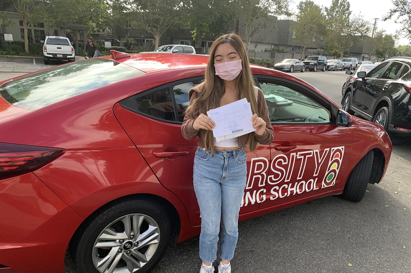 Driving School for Behind the Wheel Training in California Student Standing Next to a Training Vehicle