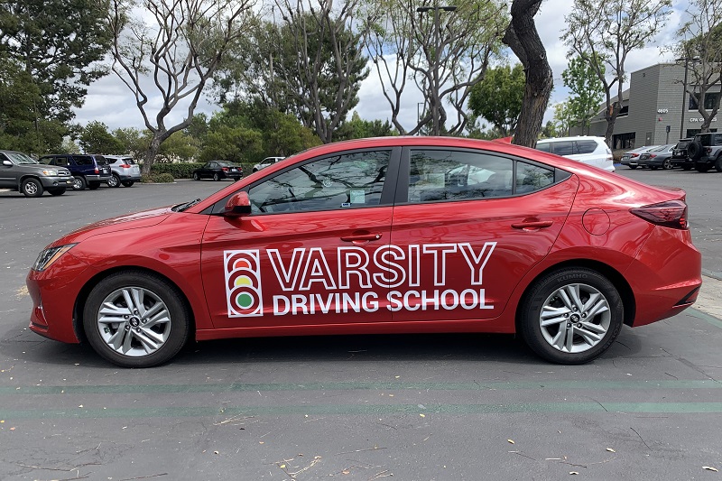 Where does Varsity Driving School Drive to in Orange County for Parents Training Vehicle Parked in a Parking Lot