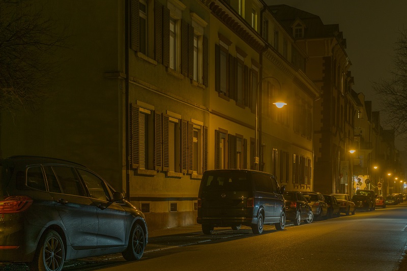 Parallel Parking Steps View of a Building with Cars Parked Along the Curb and an Open Spot Between Two of Them