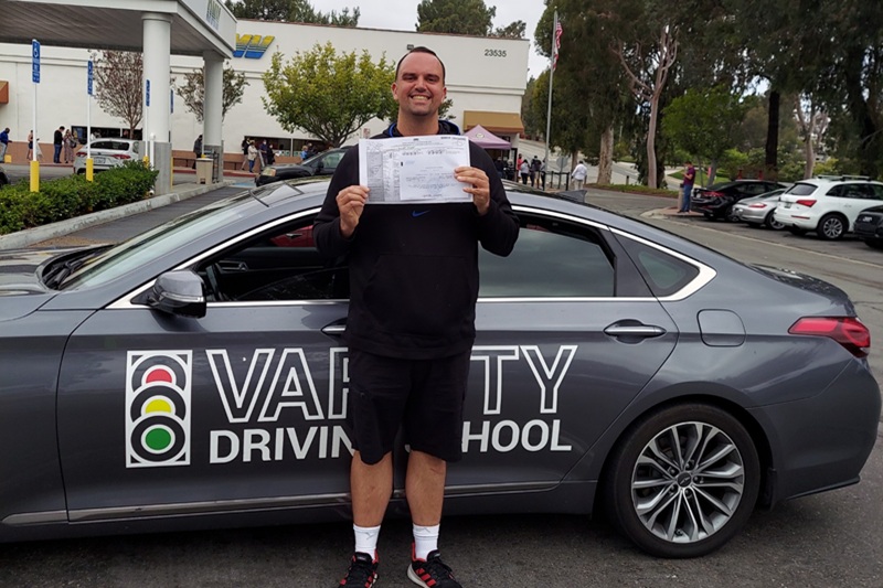 Which Adult Driving School is Best in Newport Beach Adult Standing Next to a Training Vehicle